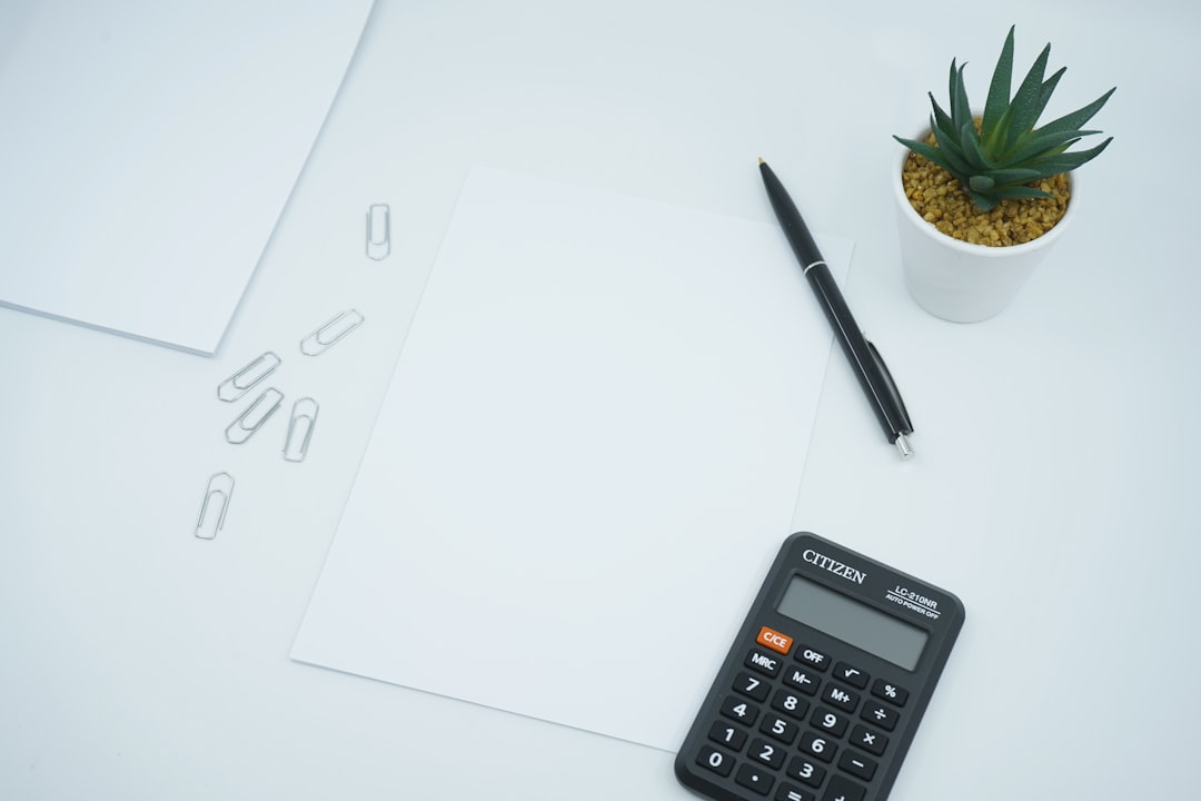 Mastering the First Impression: Your intriguing post title goes here A financial and money themed photo featuring a blank paper on a desk next to a pen and calculator. Crunch the numbers!